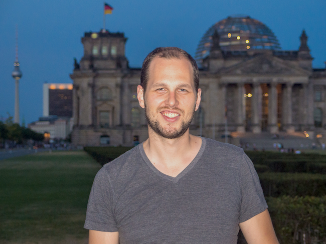 Adam standing in front of Bundestag in the evening