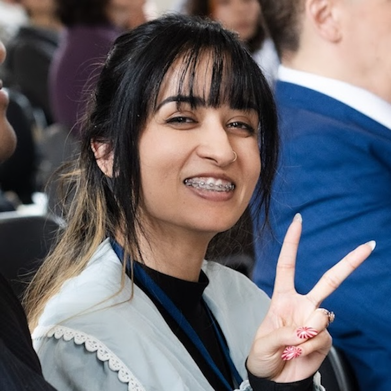 Mala giving the peace sign