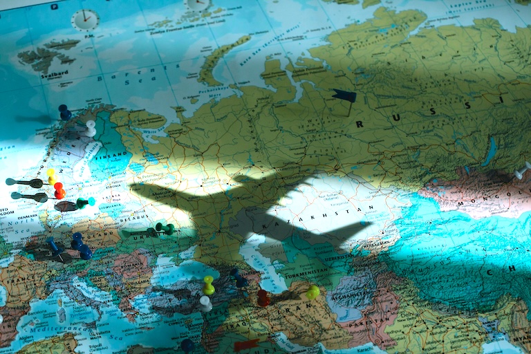 Airplane shadow on a map of the world