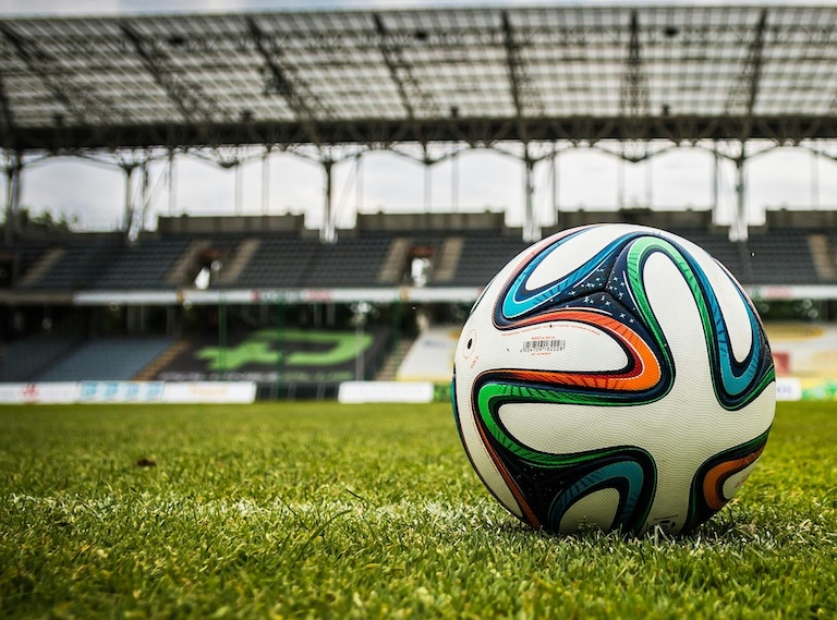 Soccer ball on grass in a stadium