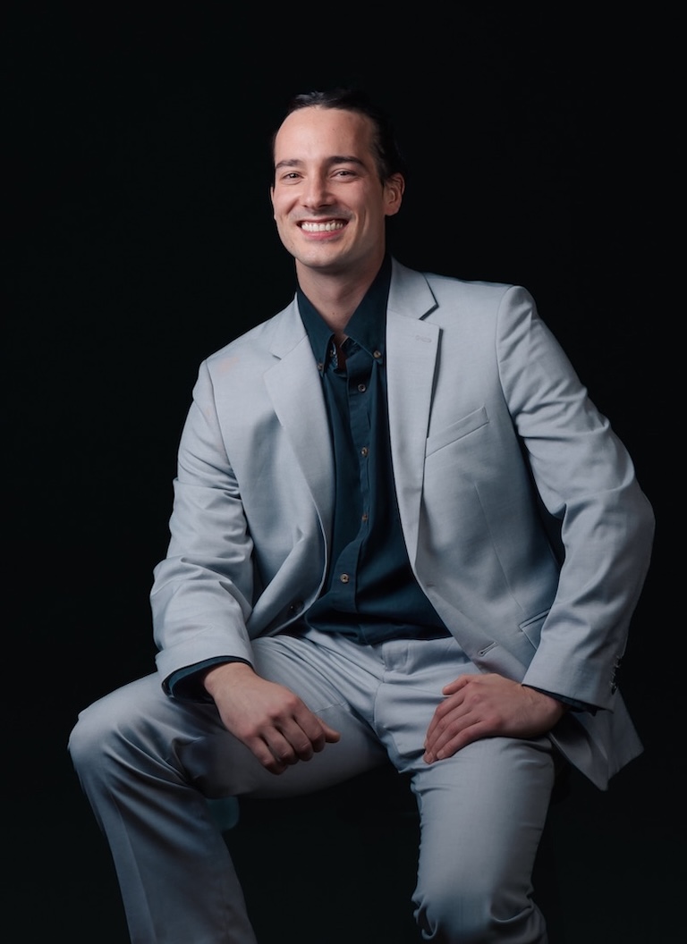 Dallas sitting in a suit.