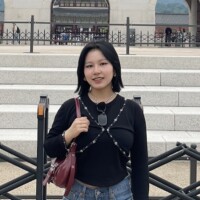 Jaehee standing in front of a staircase