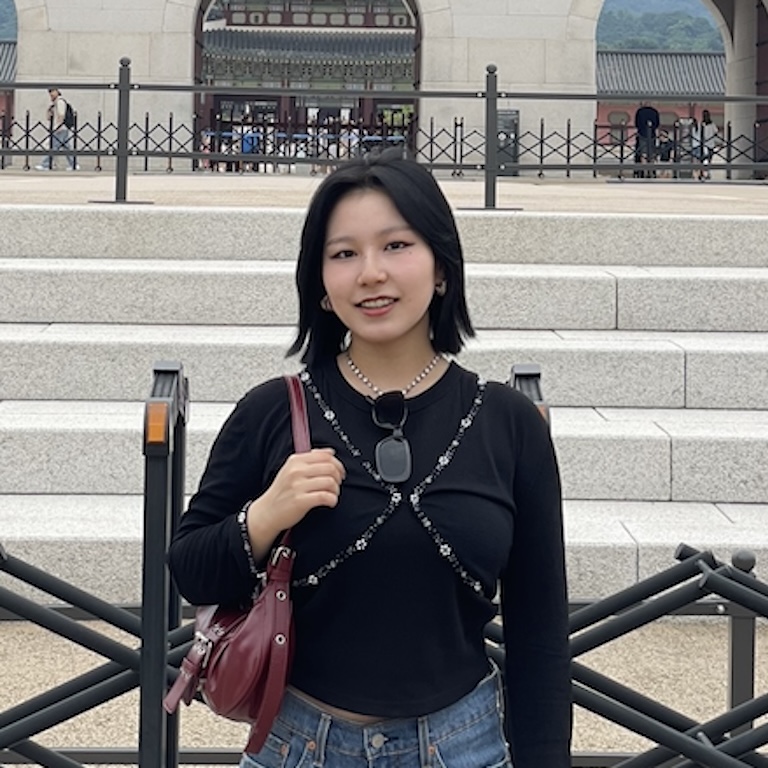 Jaehee standing in front of a staircase