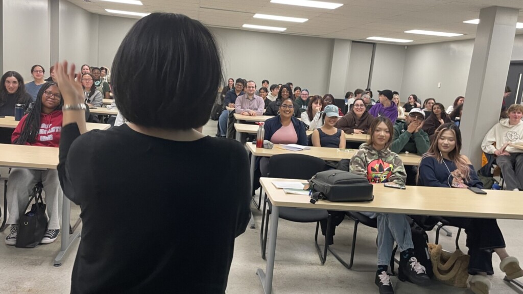 Dr. Suh speaks to a classroom filled with students