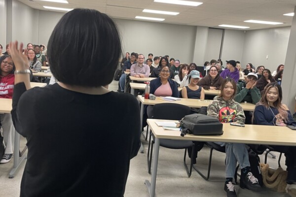 Dr. Suh speaks to a classroom filled with students