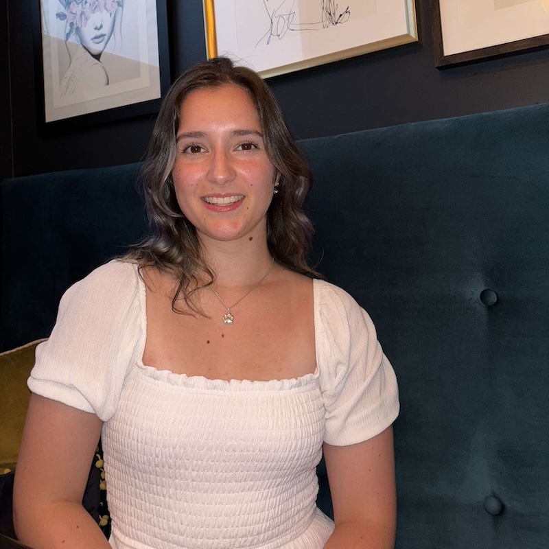 Emma standing in front of a gallery wall