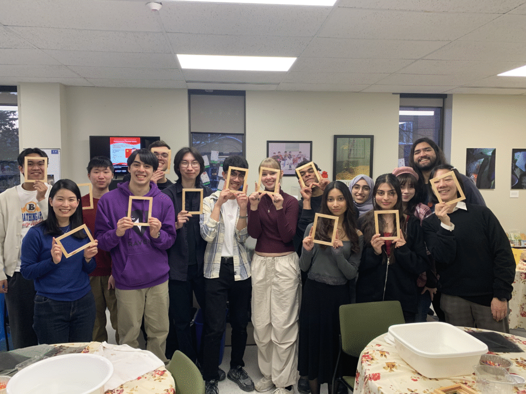 Group poses with their washi frames in front of their faces