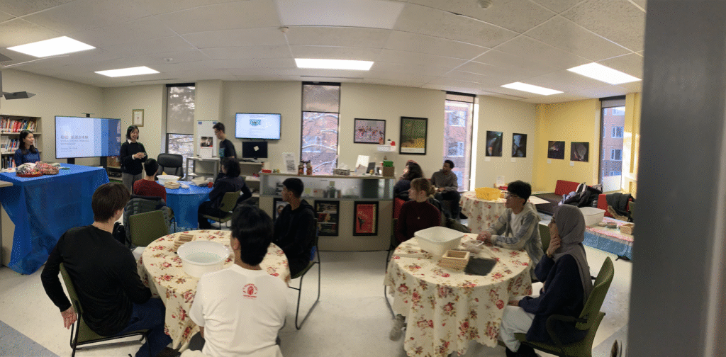 Group shot of the LLRC shows students sitting around at tables covered with table cloths.