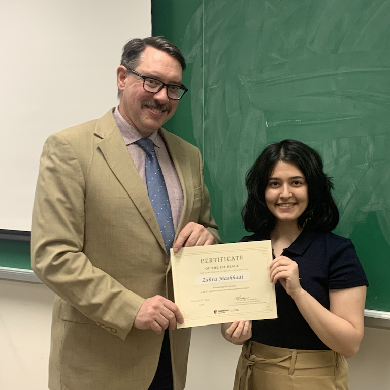 Zahra receives certificate from Michael Rodgers.