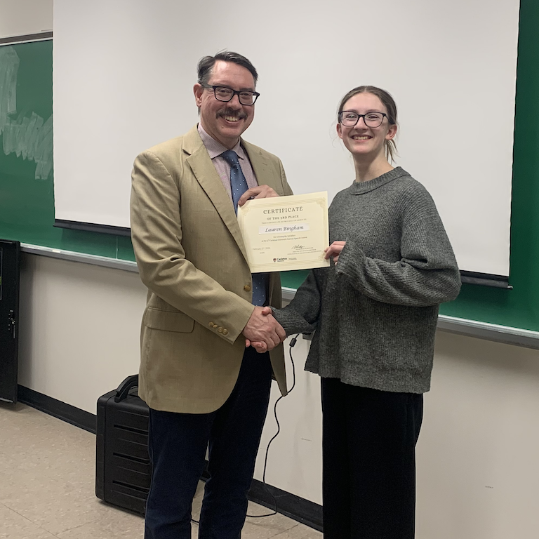 Lauren receives certificate from Michael Rodgers.