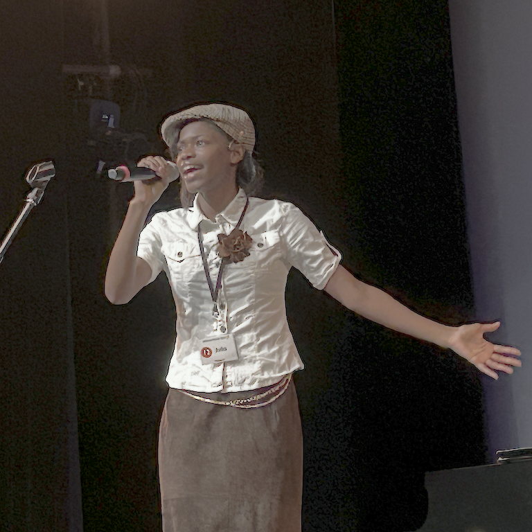 Julia belts it out dressed in a cabbie hat