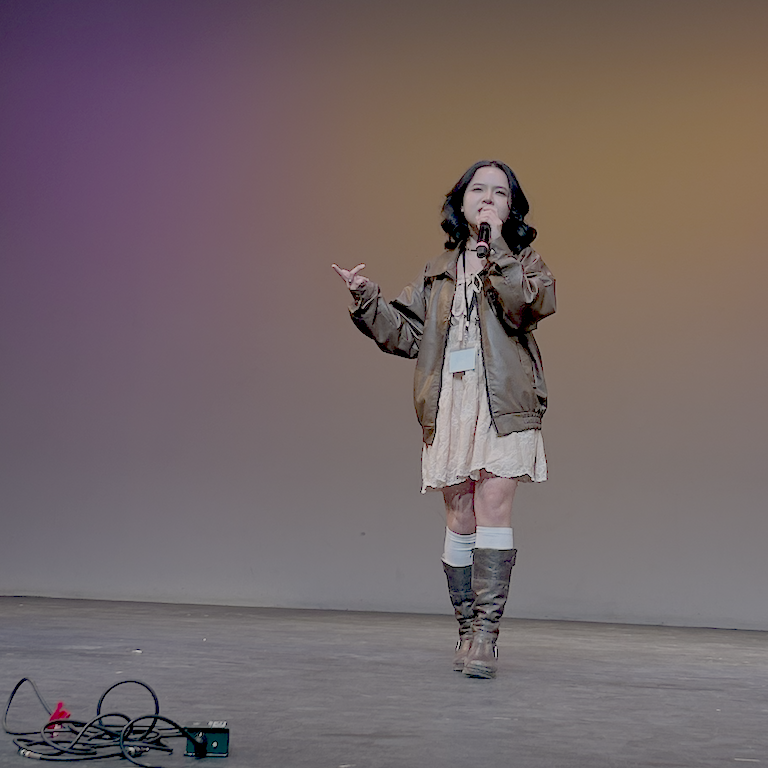 Chi walking with attitude in boots and leather jacket.