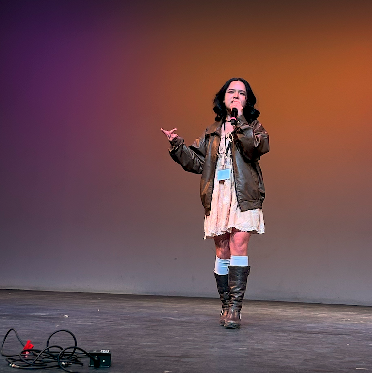 Chi walking with attitude in boots and leather jacket.