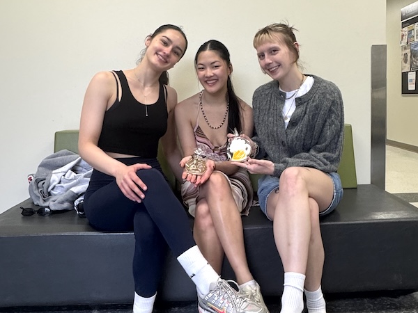 Three girls pose with their cookies.