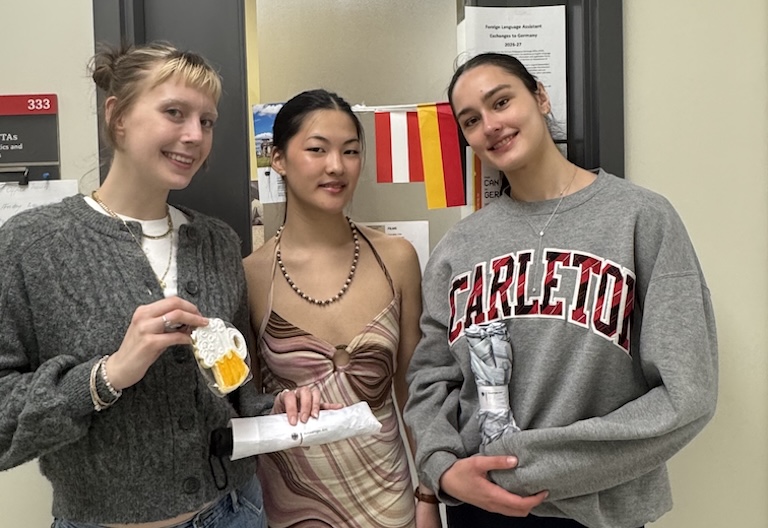 Maggie, Mia, and Clara pose in front of the German office
