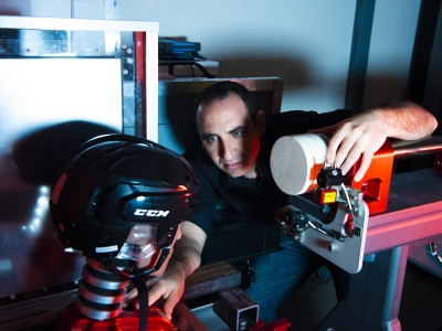 A middle-aged white man working with a large piece of equioment