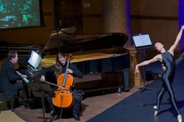 Pianist, cellist and ballet dancer performing on stage.