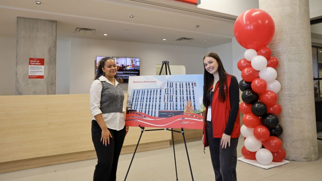 Carolyne Bergeron and a Residence Life Services employee stand in the lobby of Rideau House 