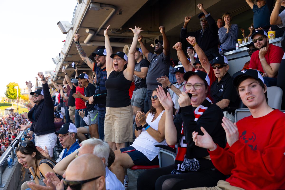 The Carleton alumni section of TD place cheer during the 56th Panda Game.