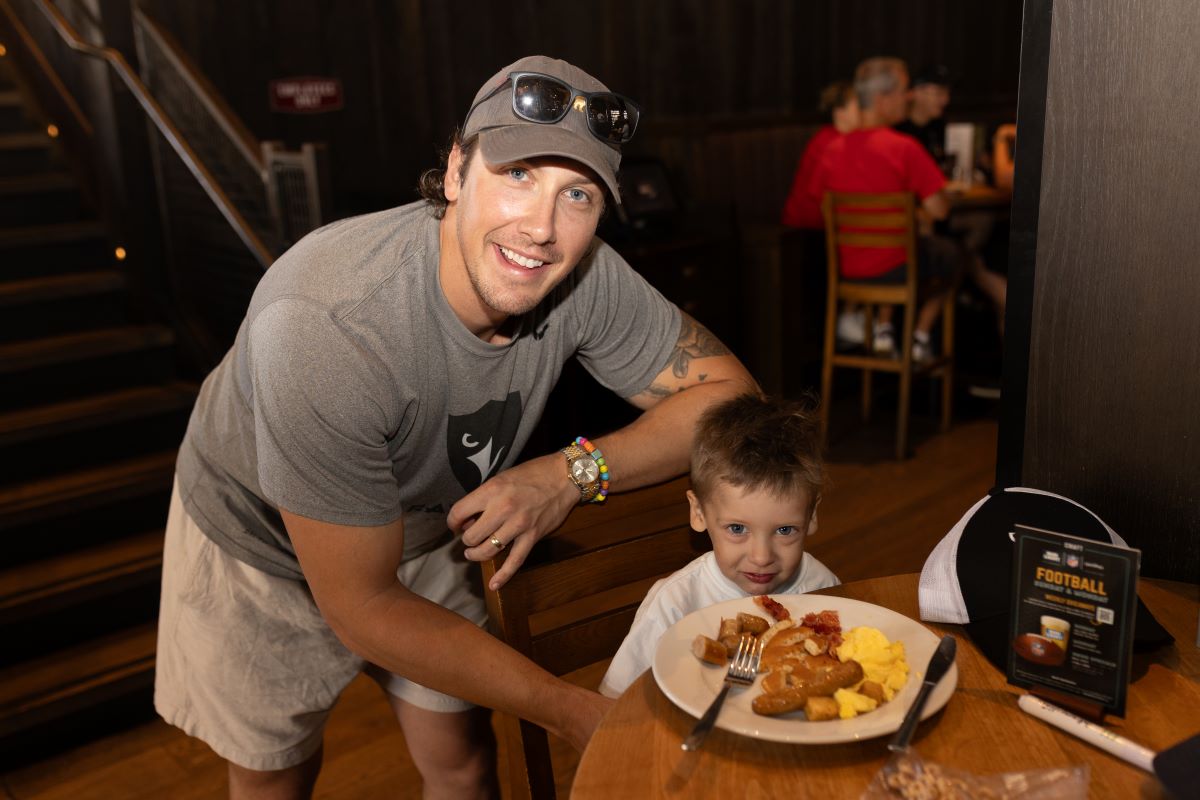 Two attendees of the Pancker Breakfast event pose for a photo while enjoying their meal.