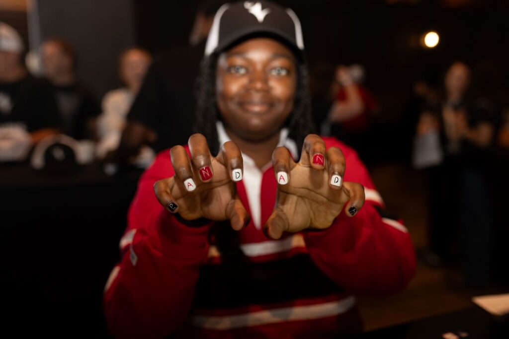 An attendee at the Pancaker Breakfast shows her red and white manicure spelling "Panda" on both hands