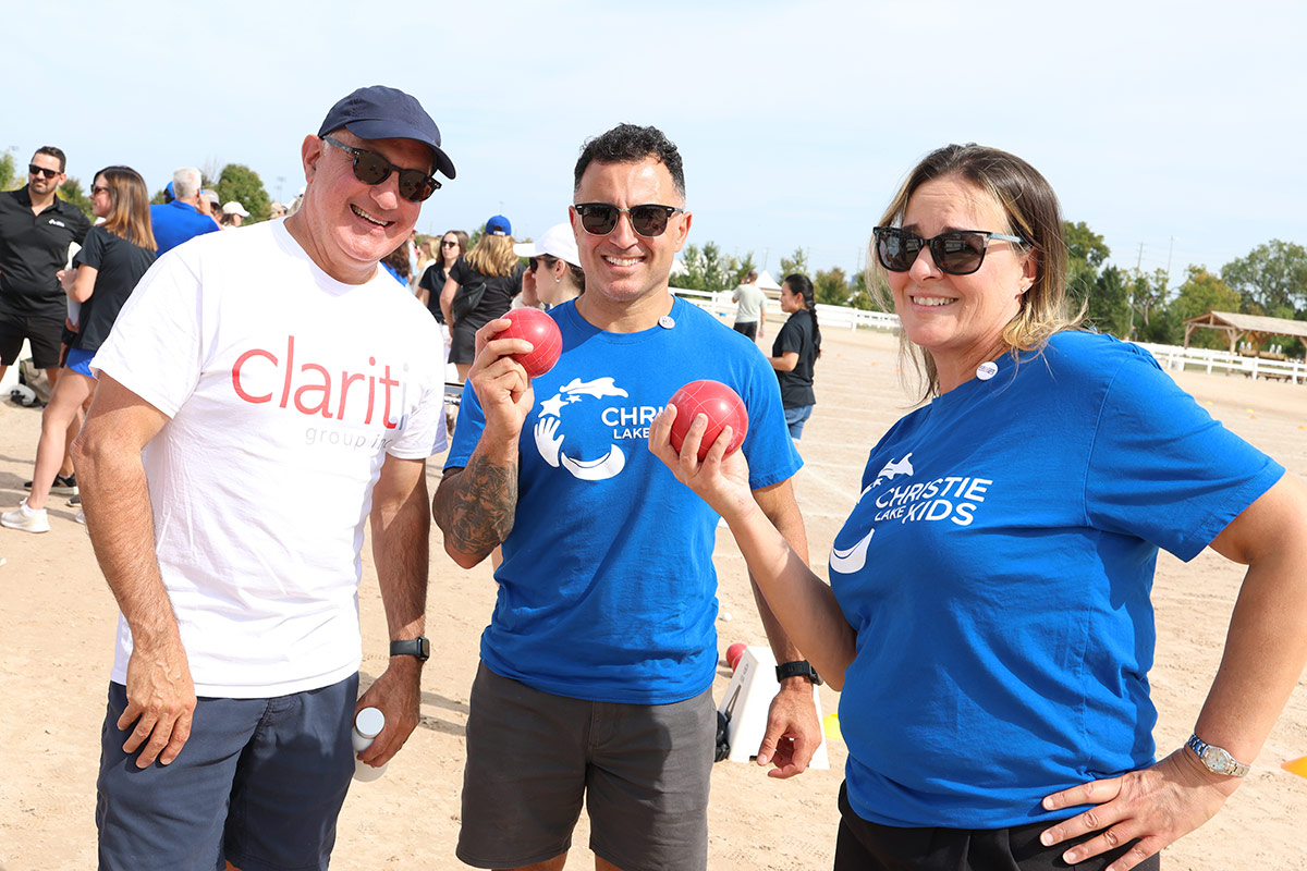 Reza Mashkoori and colleagues from Christie Lake Kids and Clariti Group smile together at a community fundraiser.