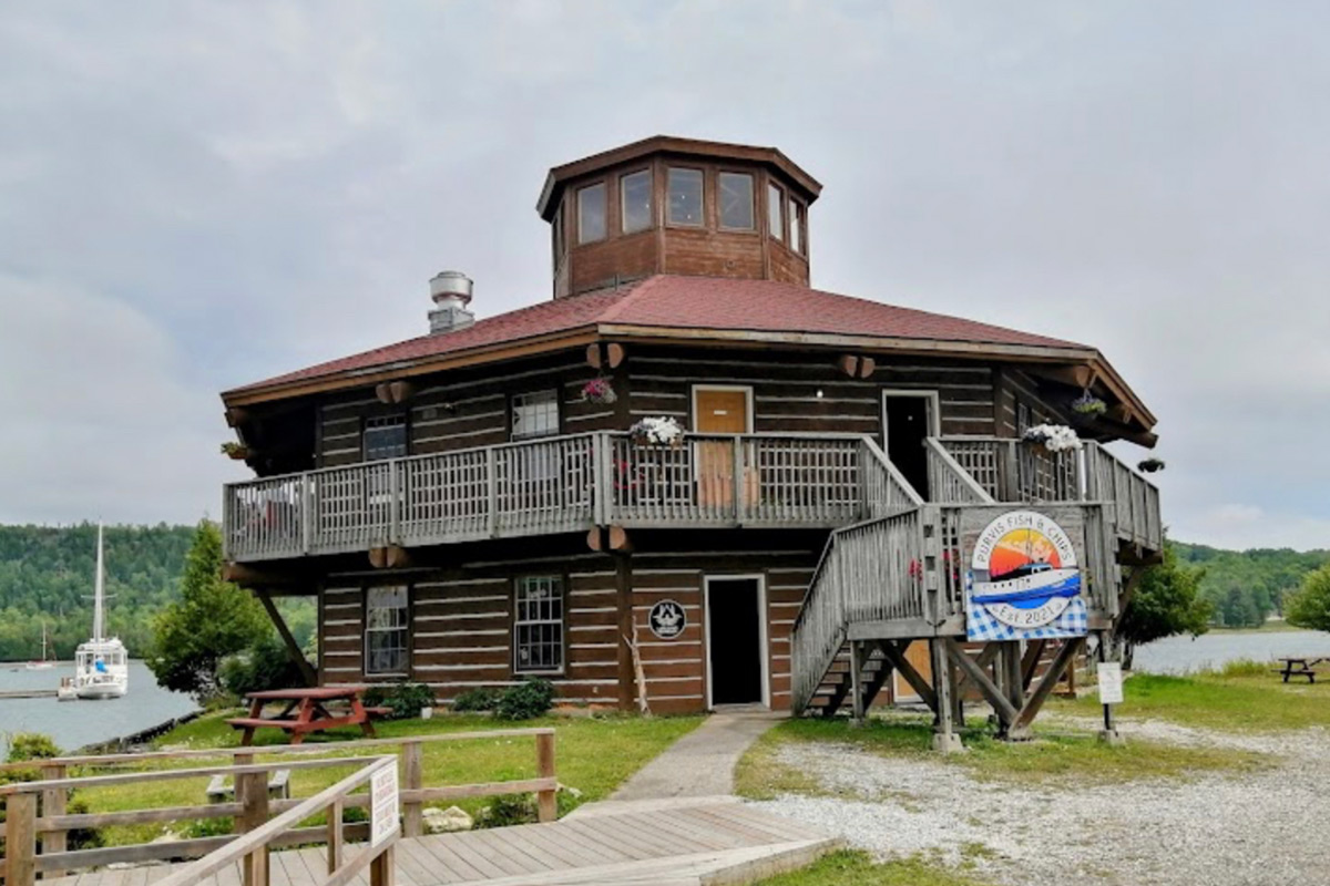 A octagon shaped building on a riverbank.