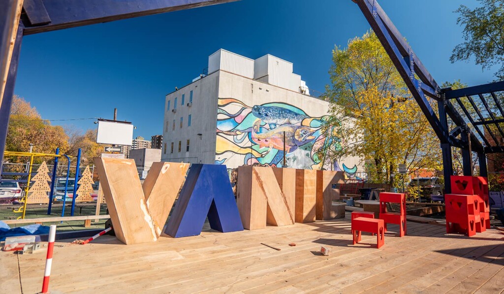 Vibrant public spaces at Vanier Hub in Ottawa, showing the completed outdoor structure and community gathering area designed through inclusive architecture.