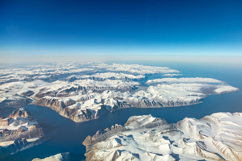 Aerial view of glacial fjords along Baffin Island coast in Nunavut.