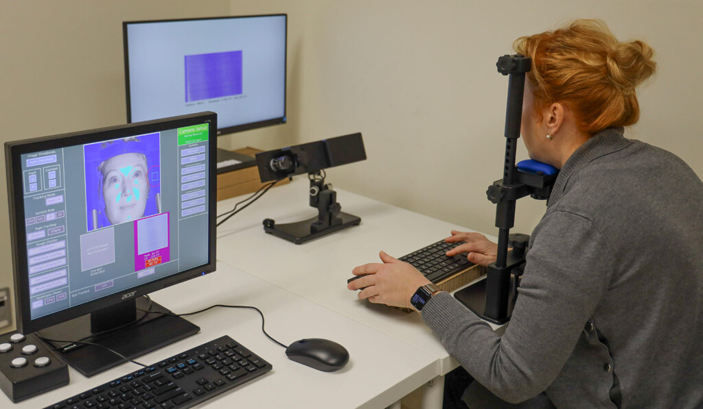 Researcher conducting eye tracking study on bilingualism and neurodiversity to understand communication and cognitive processing.