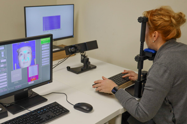 Researcher conducting eye tracking study on bilingualism and neurodiversity to understand communication and cognitive processing.