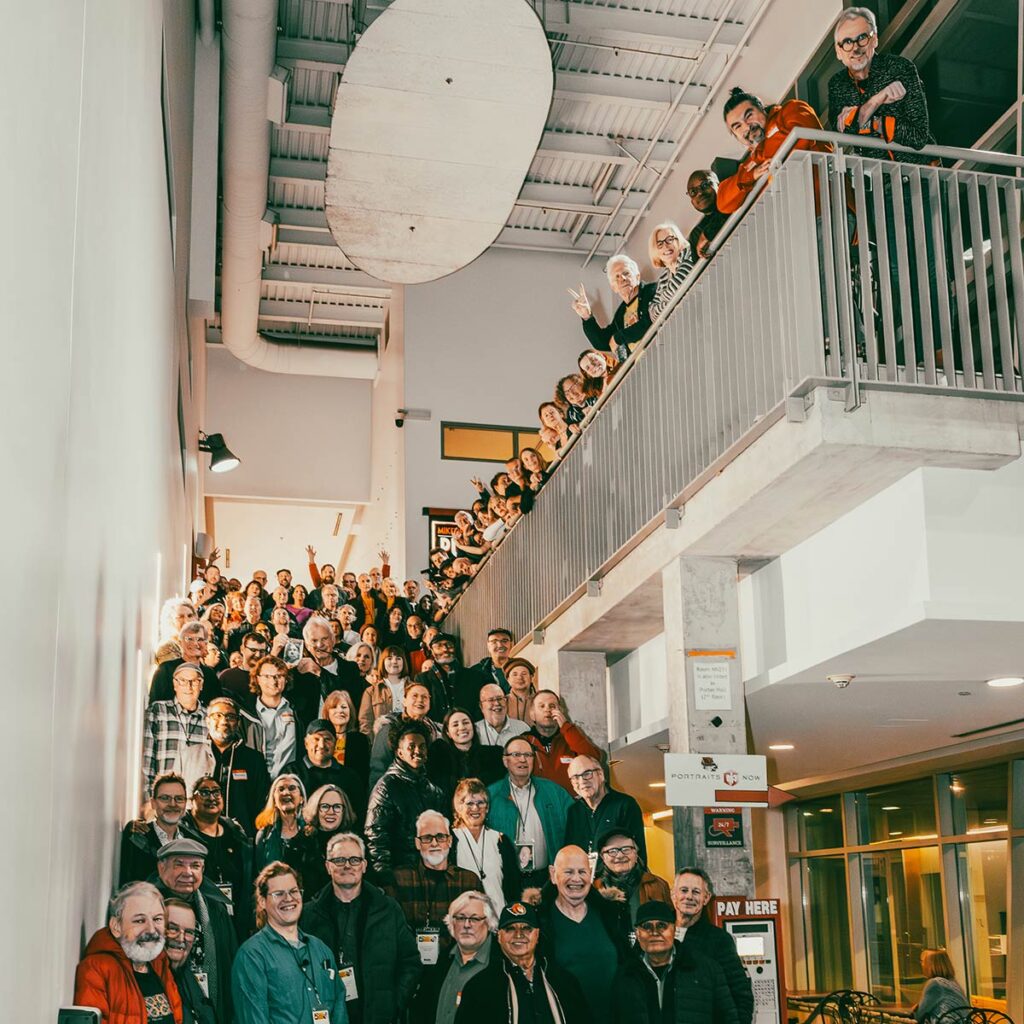 A large group of people gather on a stairwell for a photo.