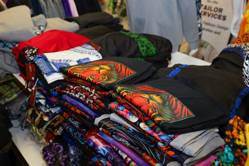 Folded t-shirts on display inside a clothing store.