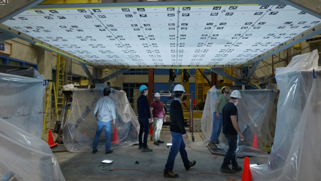 Researchers investigating the test damage caused by their earthquake simulator.