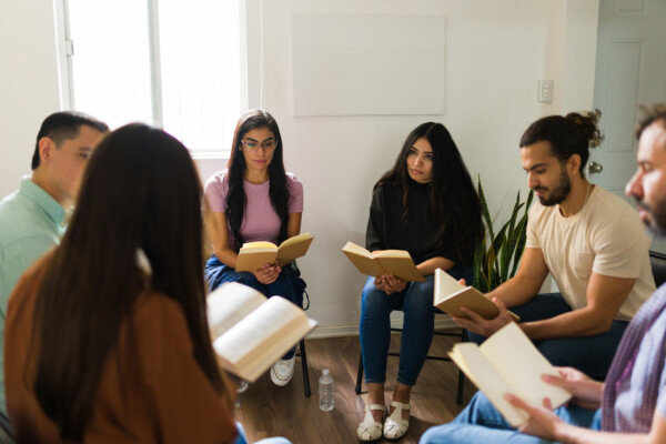 A book club group sits in a circle.