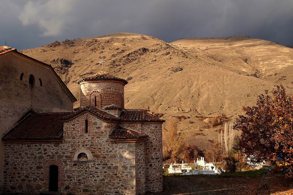 A church with a mountain in the background.