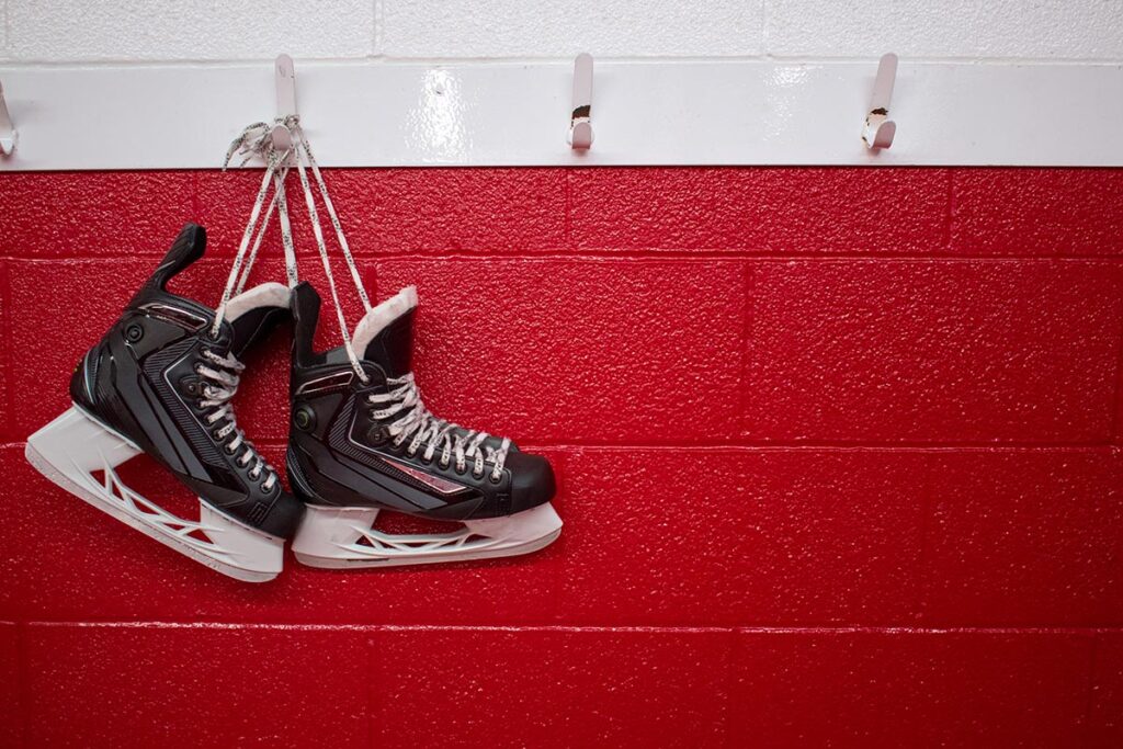 A pair of skates hanging from a wall.