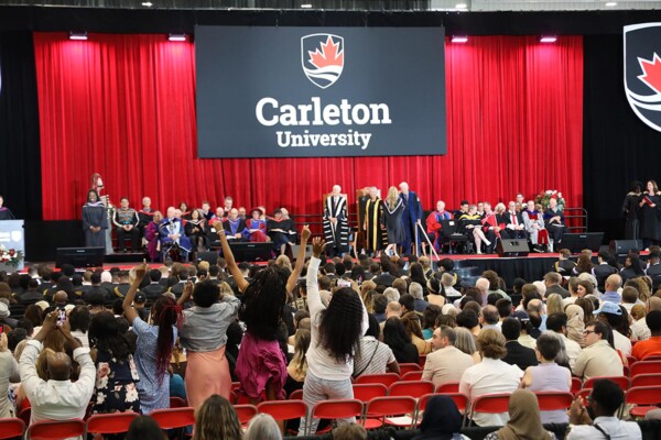 Audience members cheer at a Carleton convocation ceremony