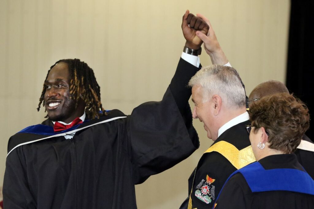 A student celebrates as he crosses the convocation stage.