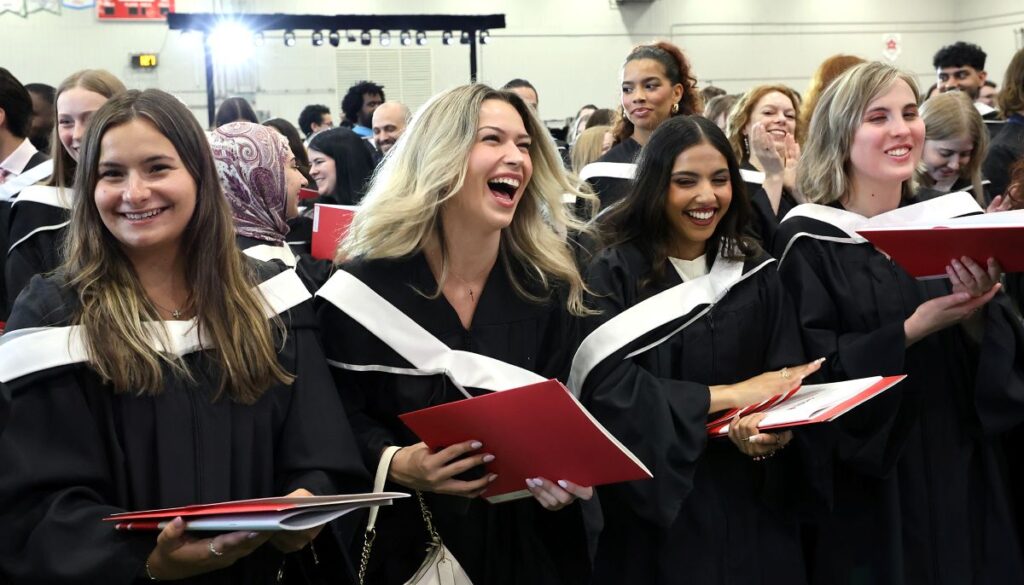 Graduating students cheer at Spring Convocation.