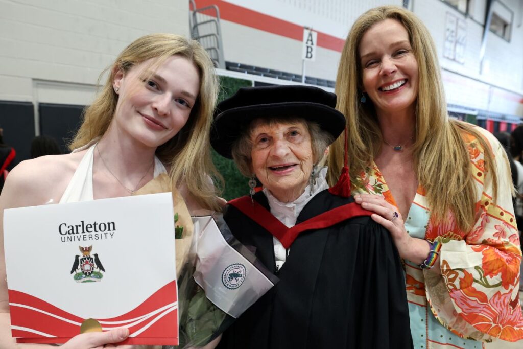 Three supporters of graduating students pose for a photo at Spring Convocation 