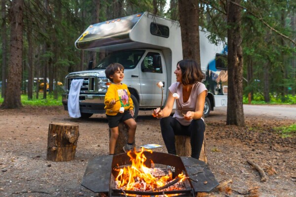 Family camping in a Canadian forest as researchers study West Nile Virus Canada risks during mosquito season.