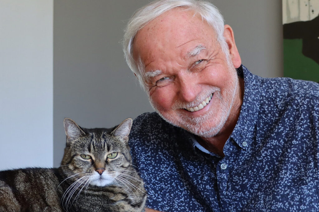 Rod Phillips, author of the book Cats: A History, poses with a cat.