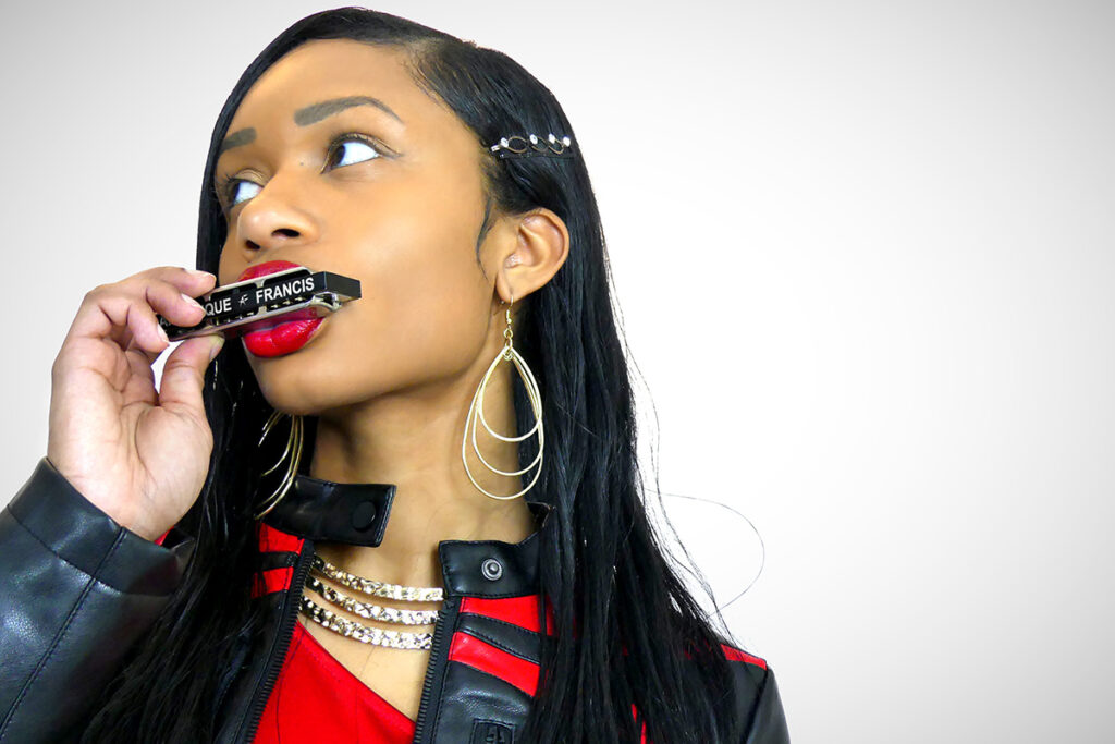 A woman playing a harmonica.