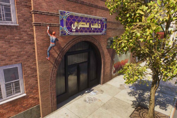 Spider-Man crawls up a brick wall in a still from the game Spider-Man 2.