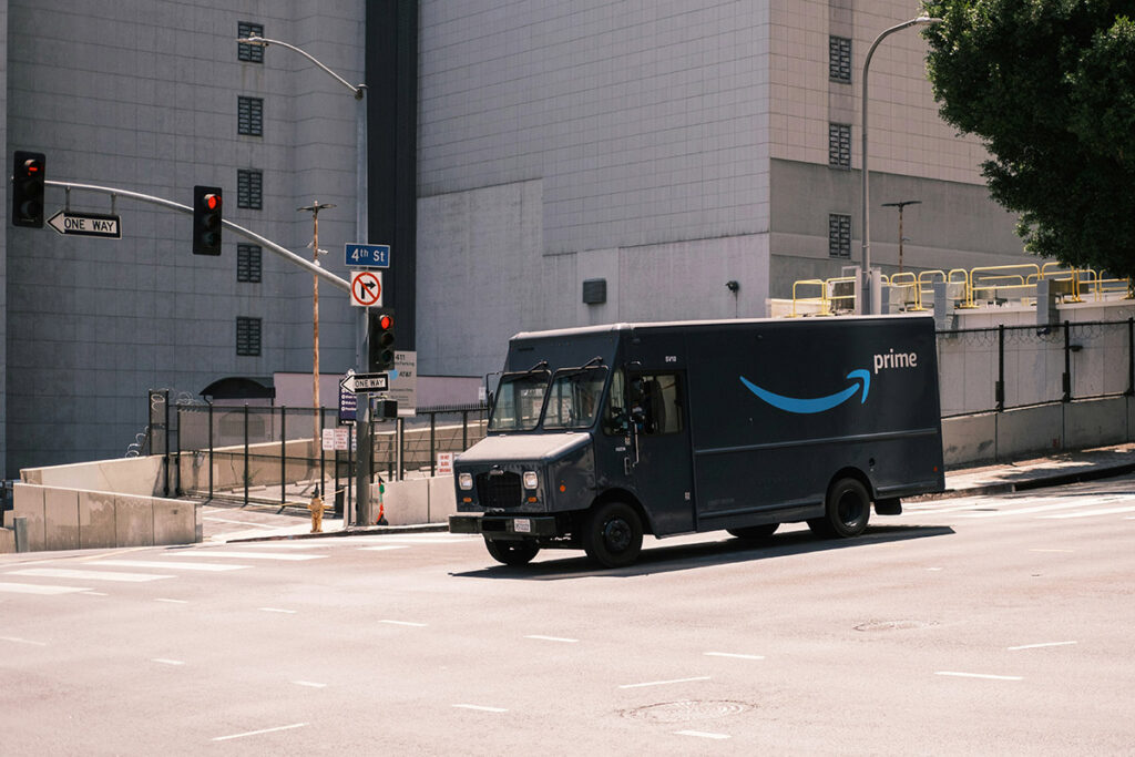 An Amazon truck waits at a red light.