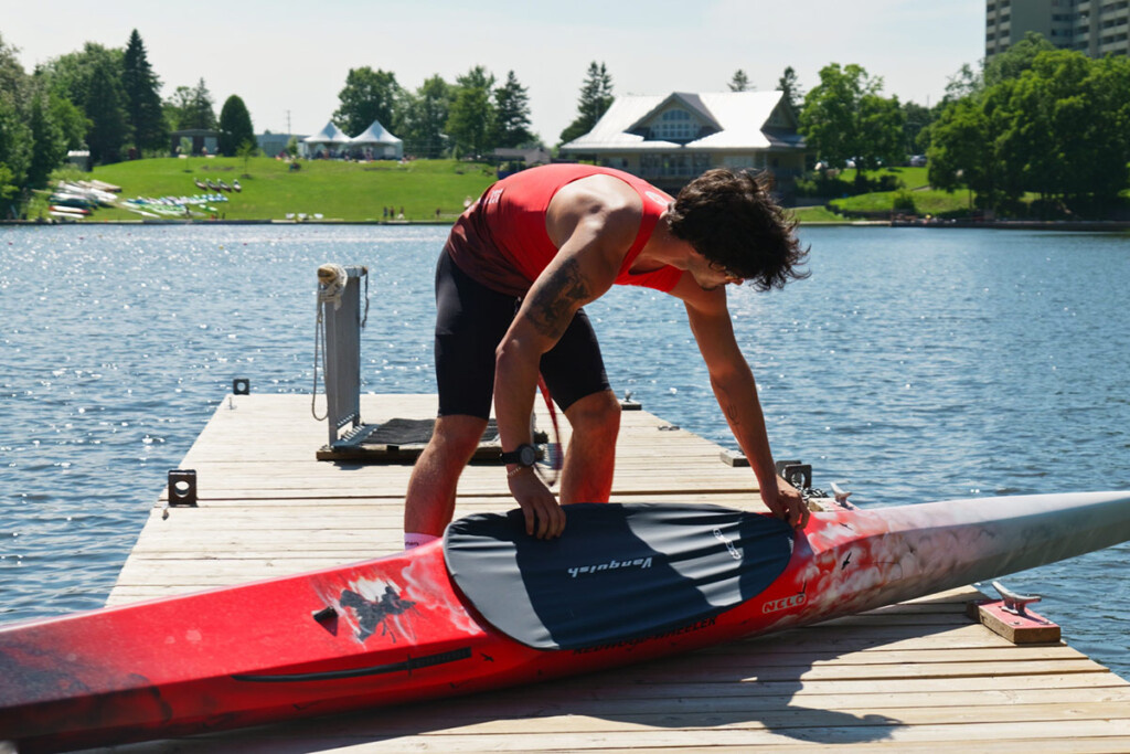 A man prepares to take his kayak out on the lake.
