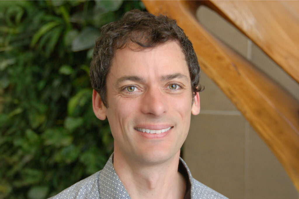 A headshot of a man wearing a dress shirt.