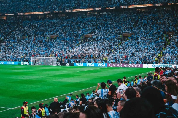 Fans celebrate during a FIFA World Cup match as debate grows over commercialization of the tournament.