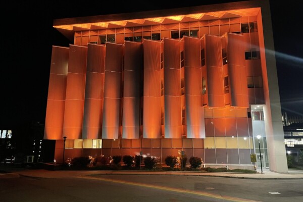 Carleton Campus building lit orange in honour of Orange Shirt Day